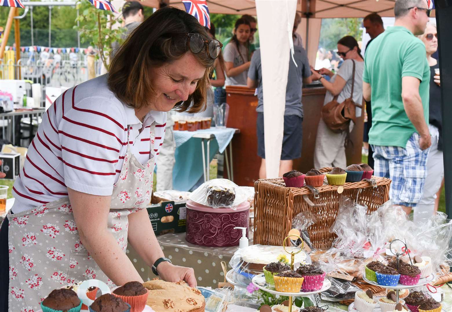 Karin Carter Keall running the cake stall. Credit: Julia Hoaen