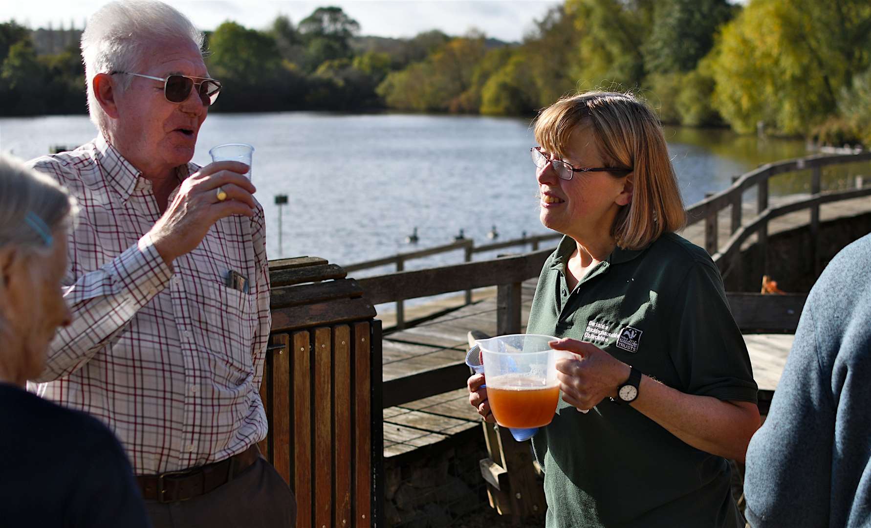 Nature Memories Officer Jone Ayres offering freshly pressed apple juice to guests