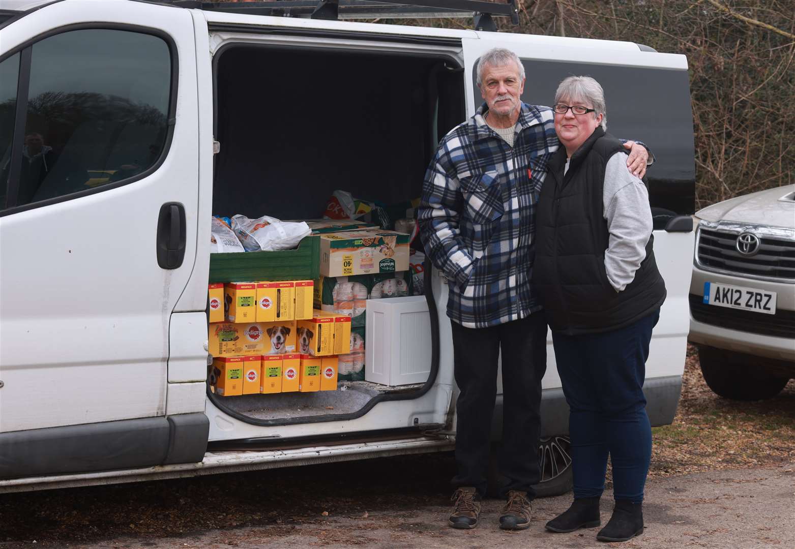 Steve and Tania with their donation of dog food. Credit: Dogs Trust