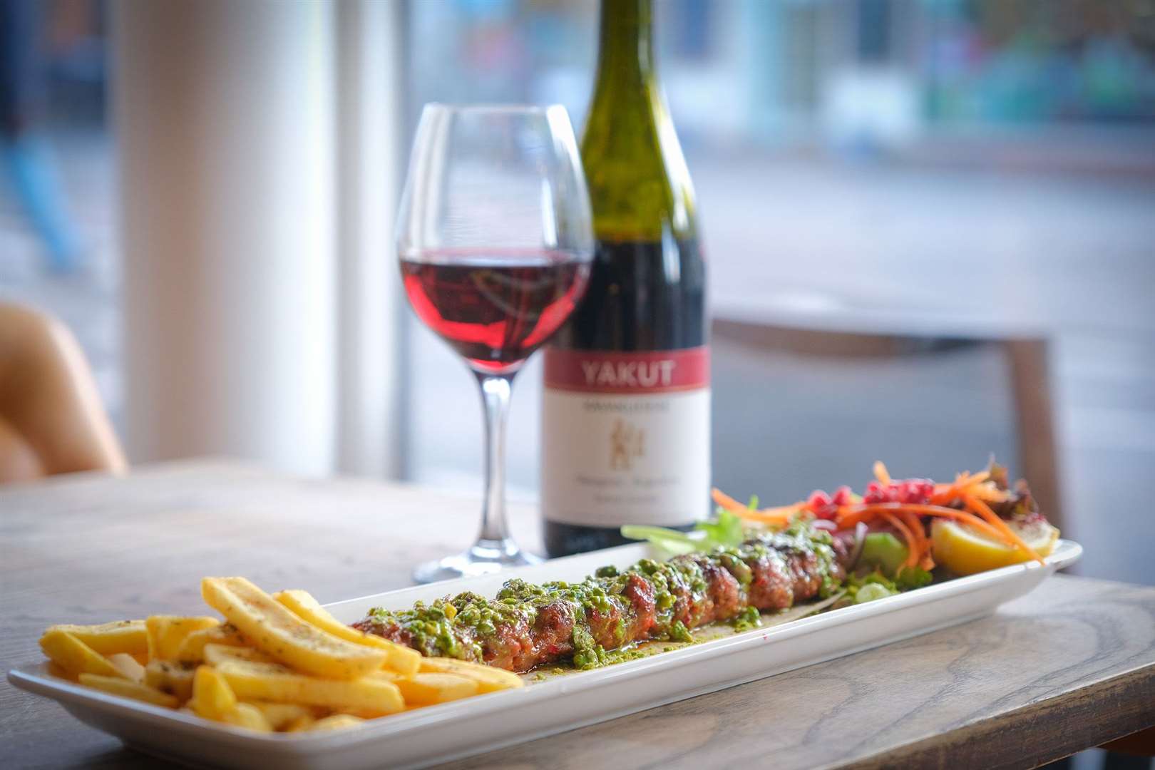 Pistachio Adana with a glass of red