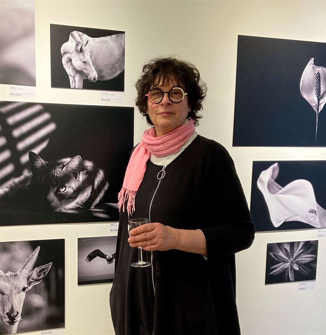 Gina Robinson by her photograph at the Coningsby Gallery