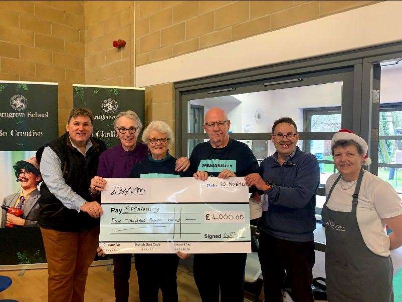 North West Hampshire MP Kit Malthouse—a regular customer at the Woolton Hill and Highclere Village Market—presenting a £4,000 cheque to Newbury Speakability, the market's 2024 charity of the year