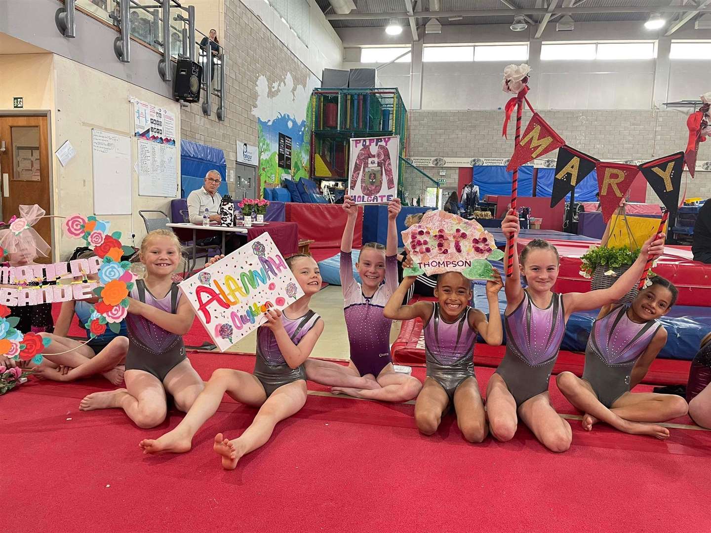 KD gymnasts with some vibrant name signs