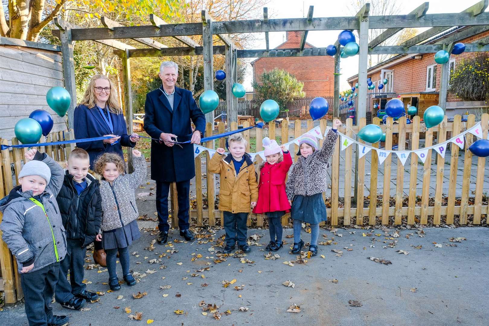 Dominic Boeck cuts the ribbon with help from headteacher Julie Lewry and pupils.