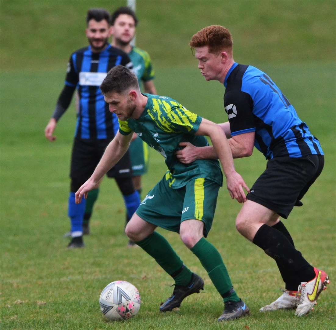Two players challenge for the ball