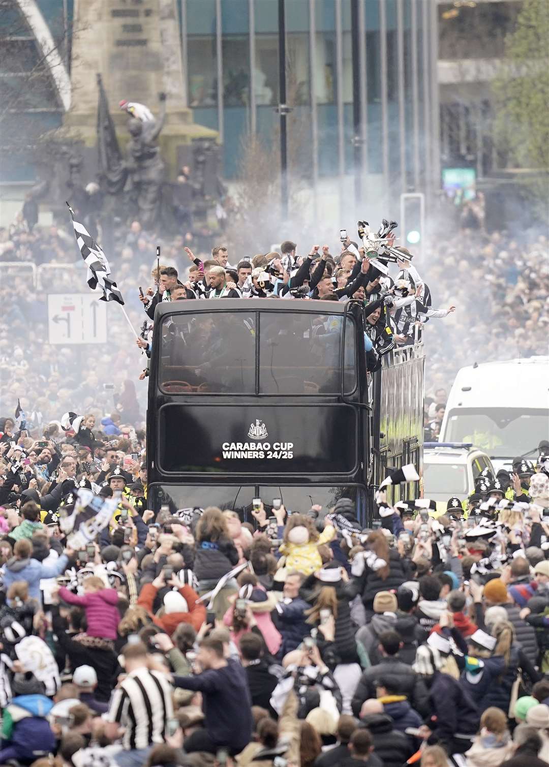 Newcastle United fans watch the Carabao Cup trophy parade (Danny Lawson/PA)