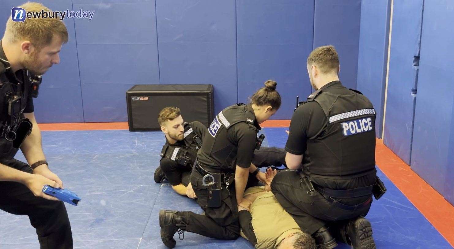 Officers restraining a vulnerable subject in a mock demonstration