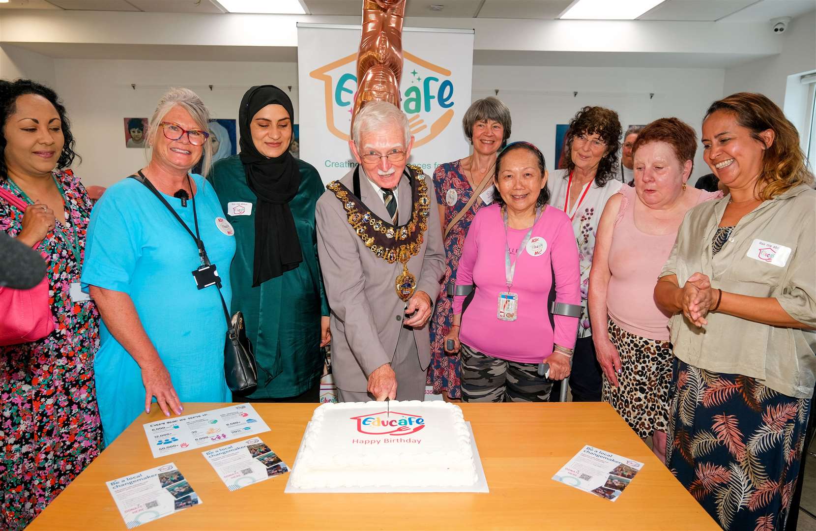 Mayor of Newbury, Andy Moore, cutting the cake at Educafe’s recent third birthday celebrations