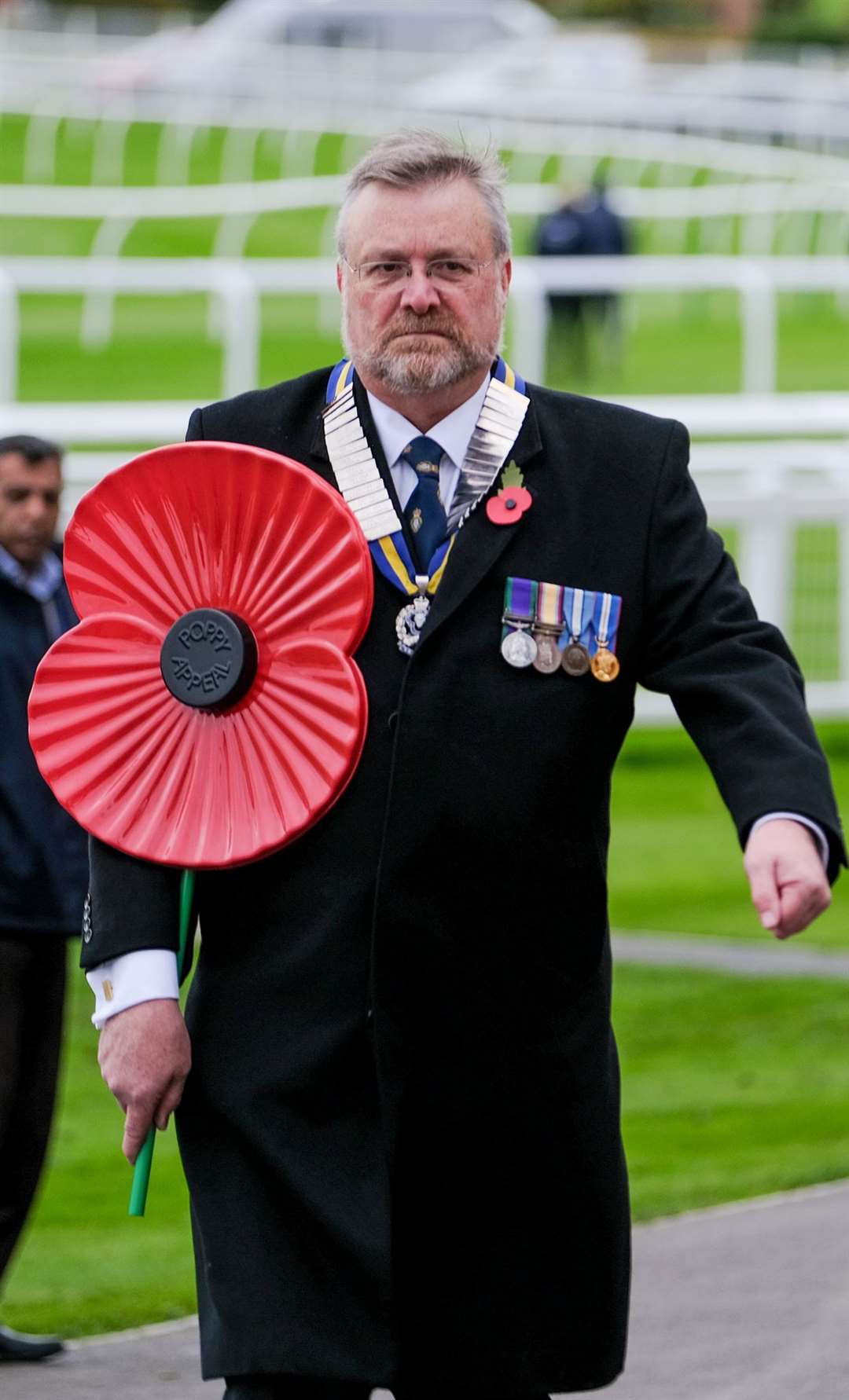 Major Jim Sibbald collected the poppy from the helicopter before taking it over to the Royal Box