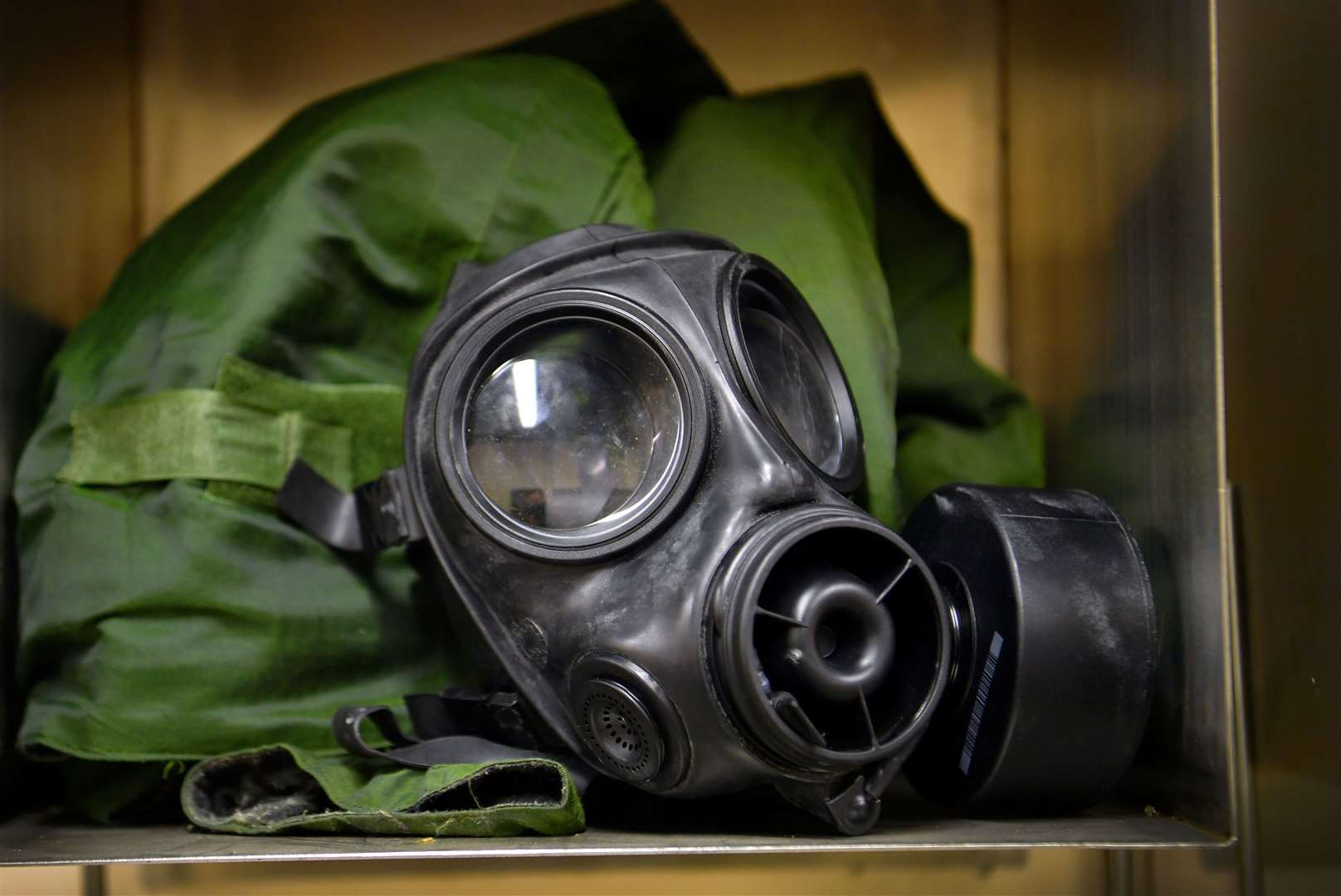 Preview piece for Heritage Weekend - The Decontamination area - A rare opportunity to gain access to the Decontamination Area within Building 274, which was 501st Tactical Missile Wing’s headquarters and command post on Greenham Air Base during the Cold War. Gas mask and protective clothing. Pic: Rob Carpenter GL