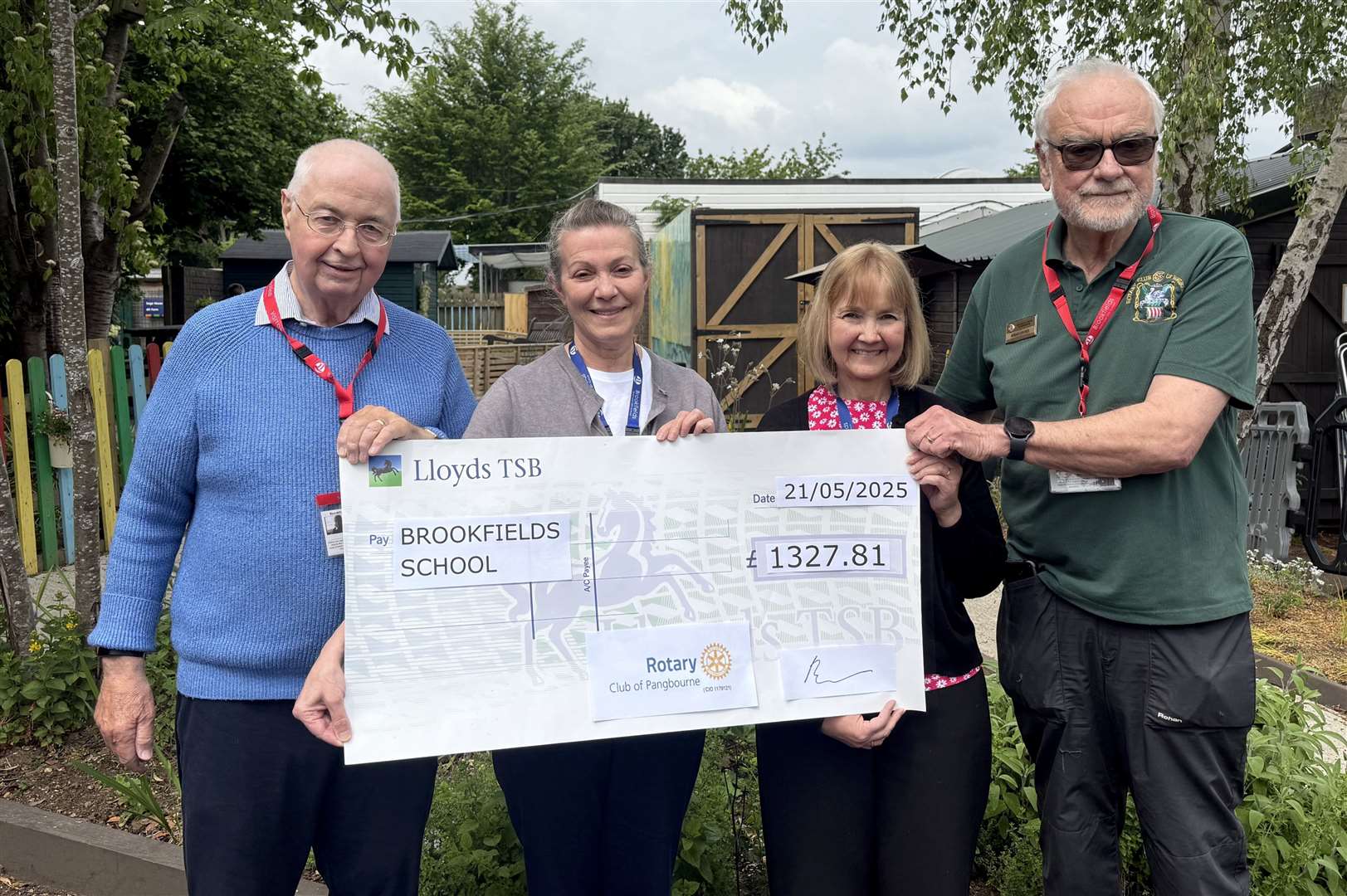 Rotarians Paul Sampson and Brian Davies presenting Art Exhibition cheque to Catherine Bernie and Charlotte Wilshire of Brookfields School