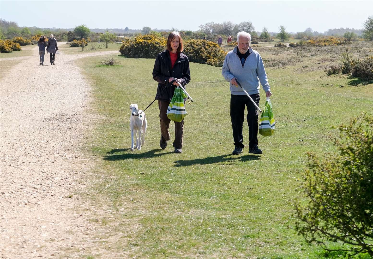 Linda and Cliff Waller picking up the dog poo bags on Greenham Common