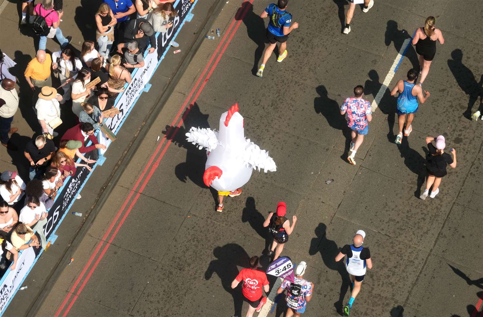 A general view from inside the viewing window above Tower Bridge of a runner in fancy dress (Jonathan Brady/PA)