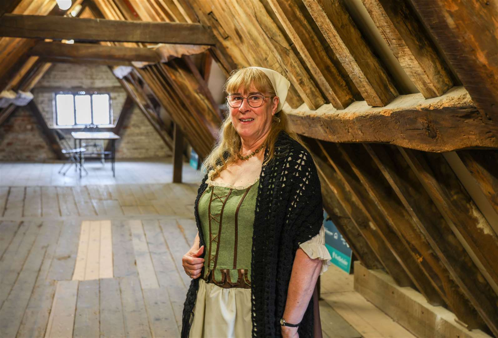 Volunteer Sue Ellis helping people to explore the museum's attic floor