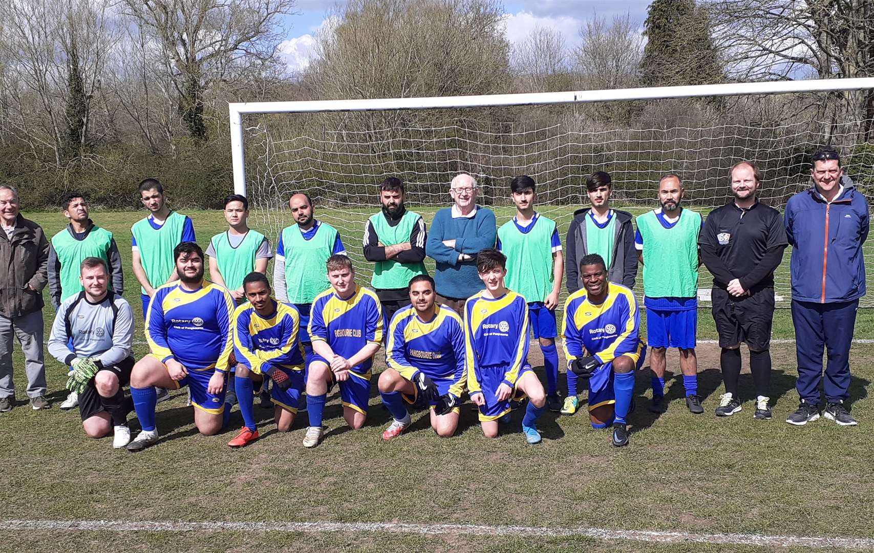 Members of both teams lined up for a squad photo