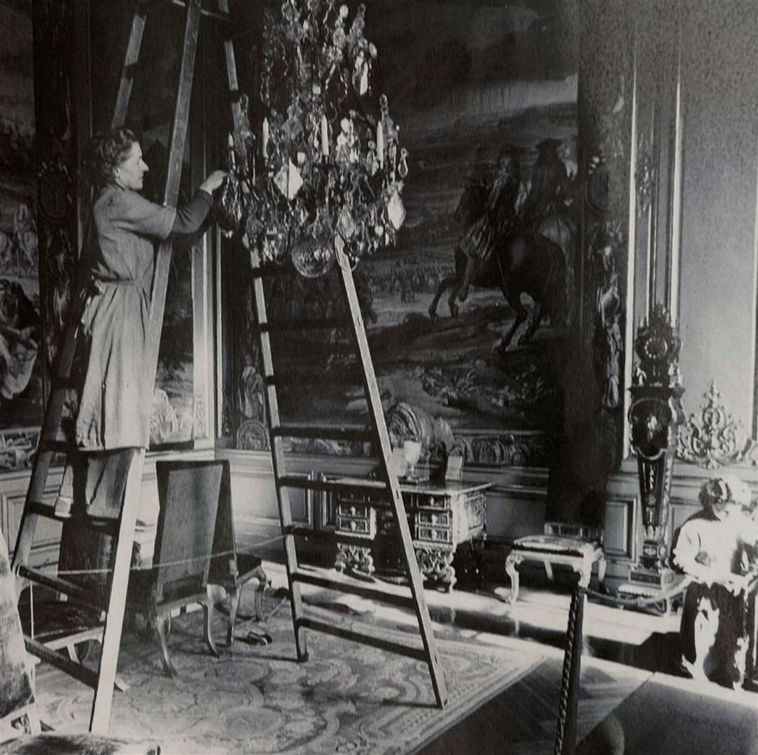 Blenheim Palace deep clean. Old photograph of the chandelier in the 3rd state room being cleaned Photographer : Mark Hemsworth