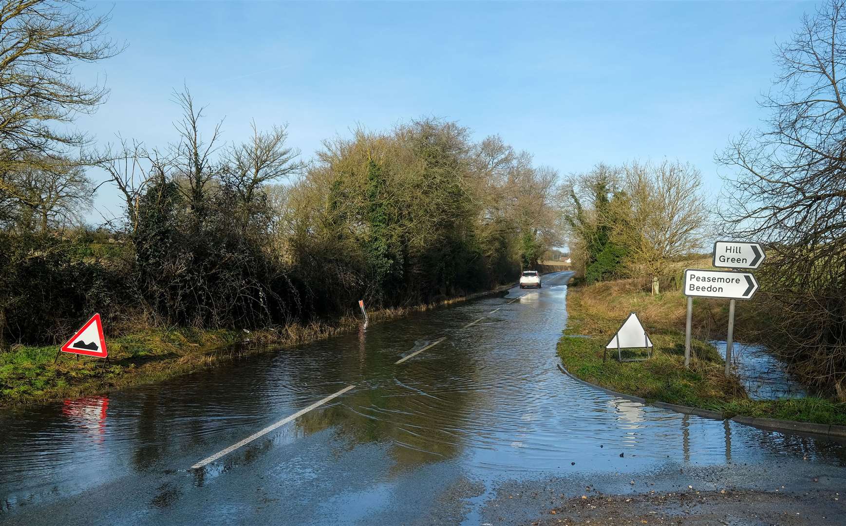 Potholes covered in flood water along B4494