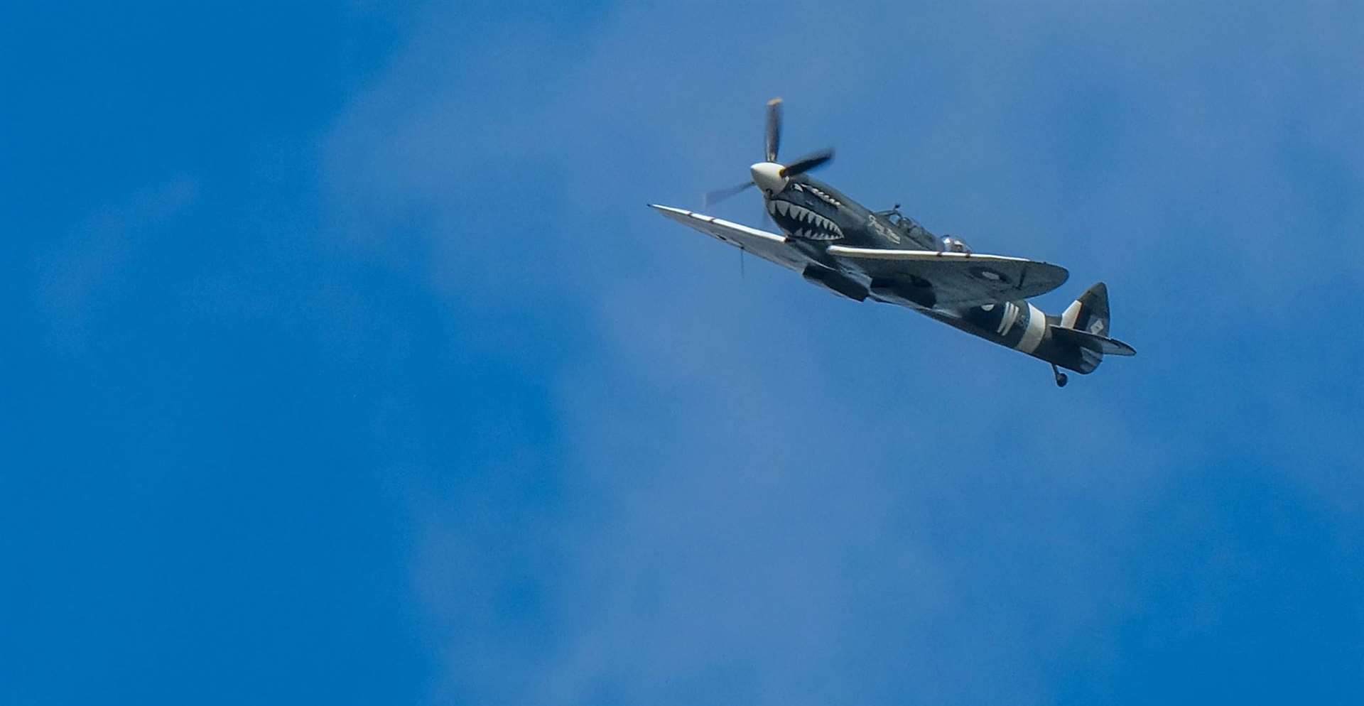 Spitfire flies over the old Quantel building in Newbury