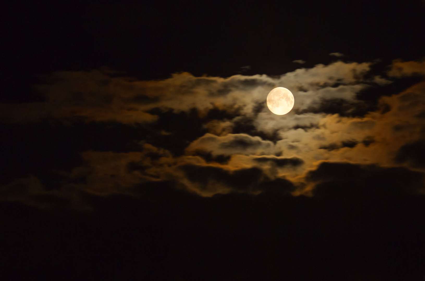 Full August Moon in the clouds