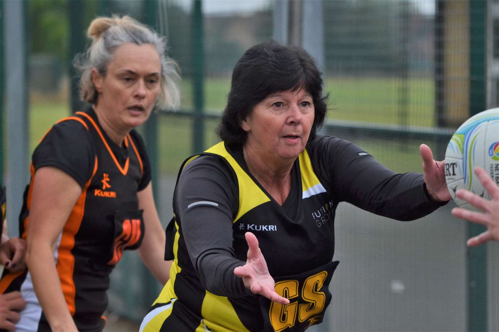 A pass is on in the netball match