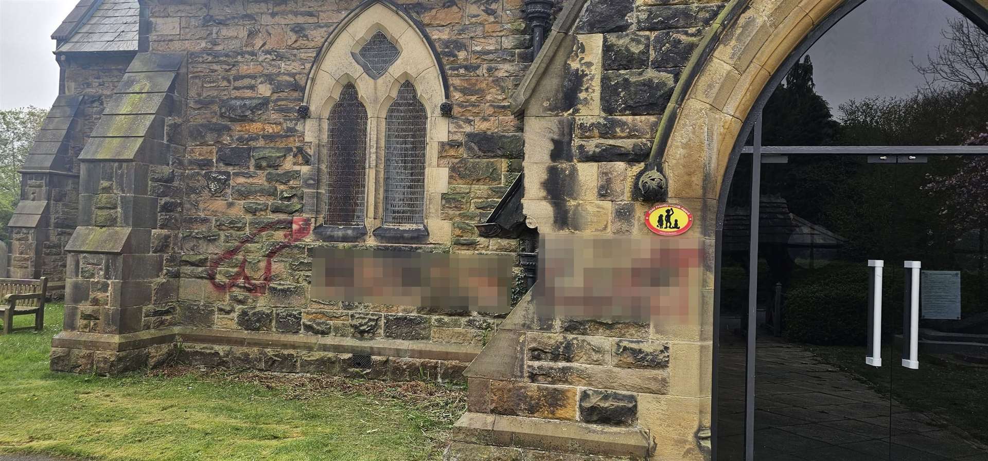 Pixelated image of the offensive phrases daubed in red paint near the door of the church (Paul Wharton-Hardman/PA)
