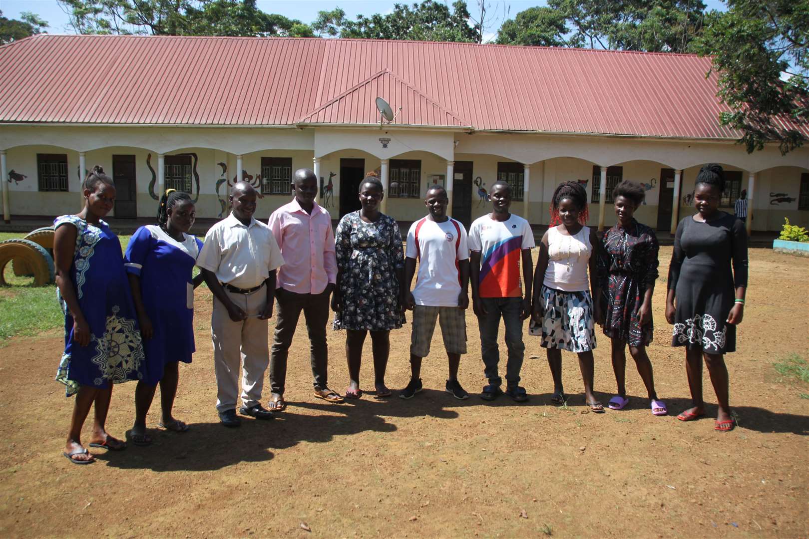 Teachers outside the new exam hall at Nabugabo Community Learning Centre, in Uganda, which donations from Pangbourne College helped to build