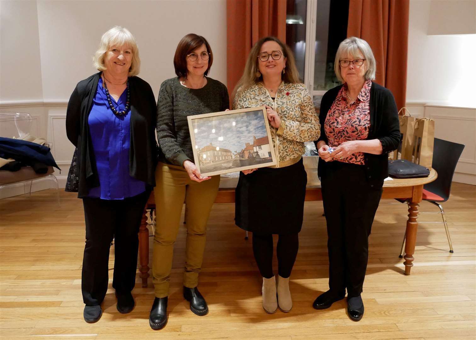 A photo of Kingsclere, a gift to the town hall. On the left is Caroline Woods, who was interpreting, along with Cormicy mayor Chantal Lantenois, chair of Cormicy Twinning Association Claudine Villaume and chair of Kingsclere Twinning Association Sue Watson
