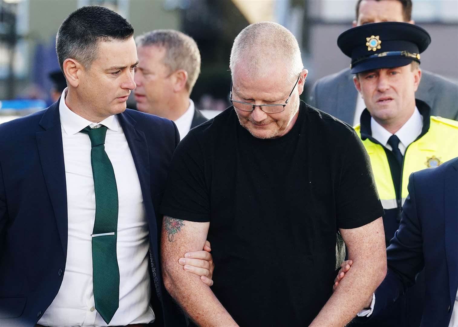 Richard Satchwell (centre) arriving at the District Court in Cashel, Co Tipperary, after being charged in connection with the murder of his wife Tina Satchwell (Brian Lawless/PA)