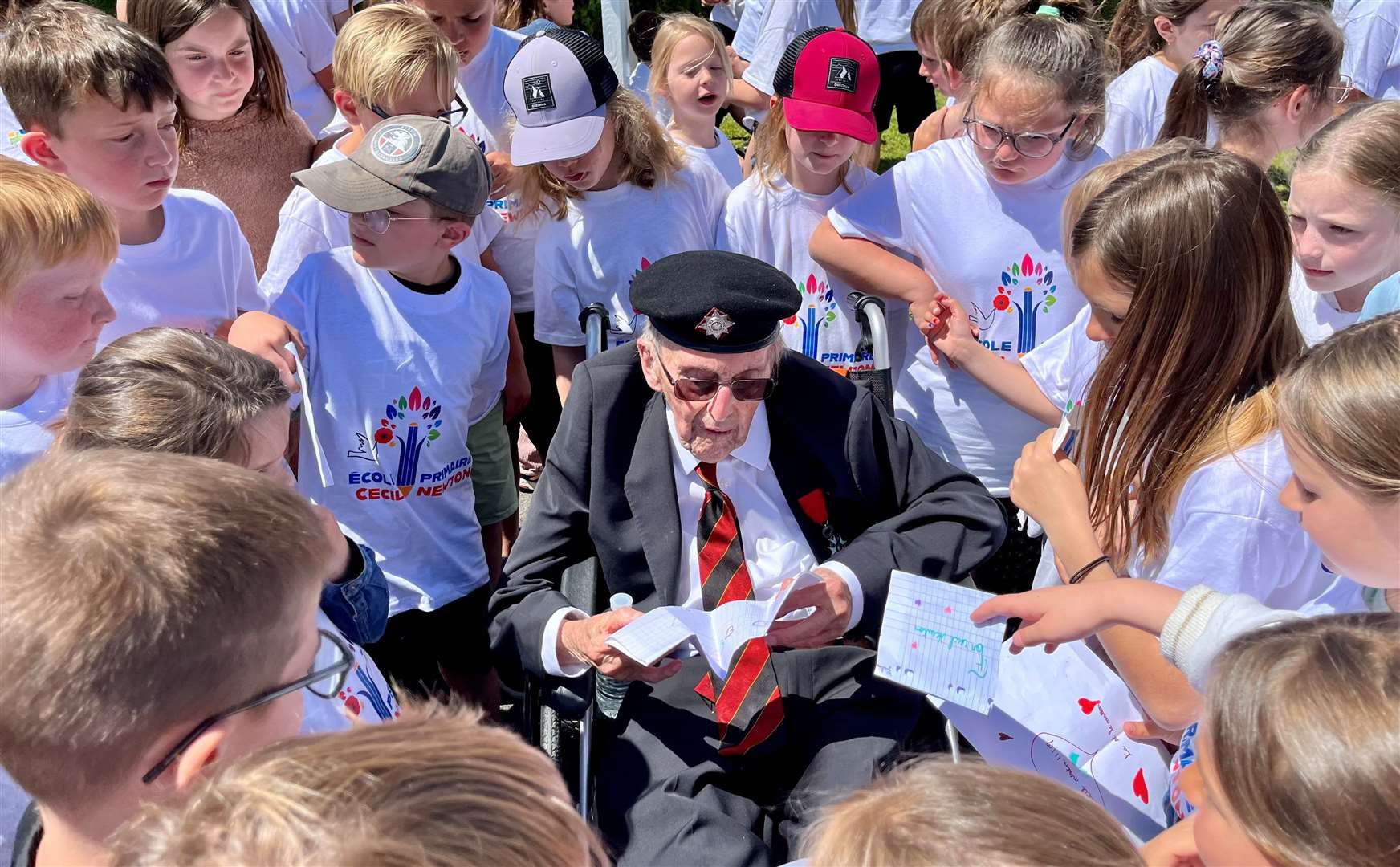 Cecil reading cards presented to him by primary school pupils. Credit: Mirek Gosney