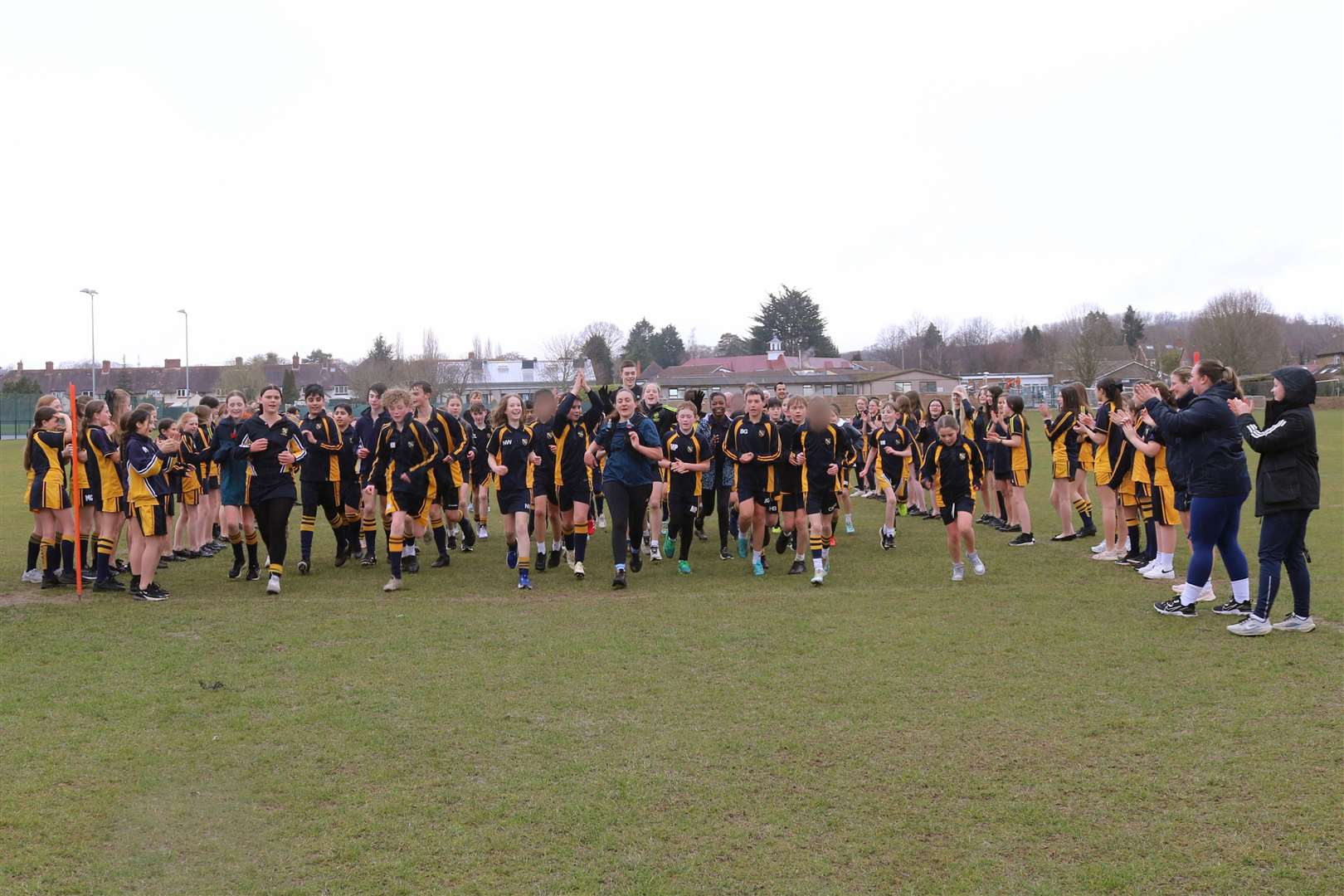 Pupils from across the school joined her on the run around the field