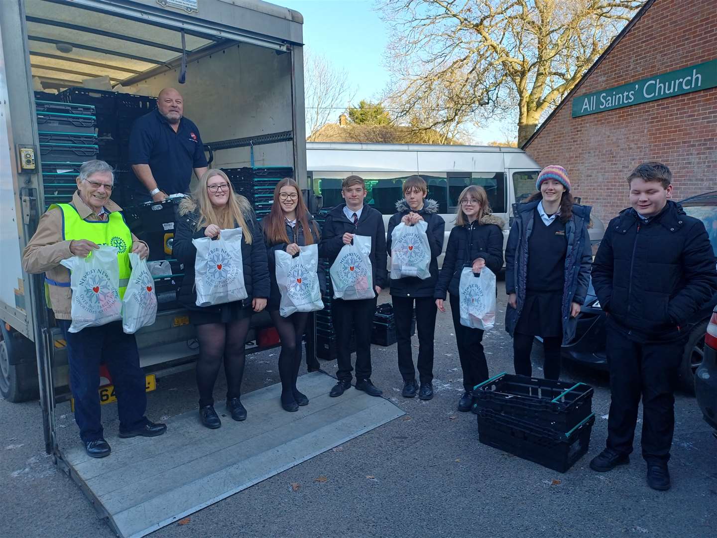 Trinity School pupils help unload the van from Swift