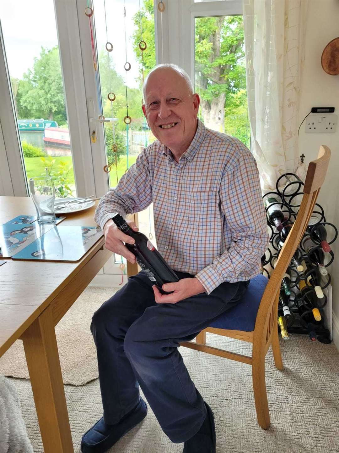 Mr H with a bottle of wine