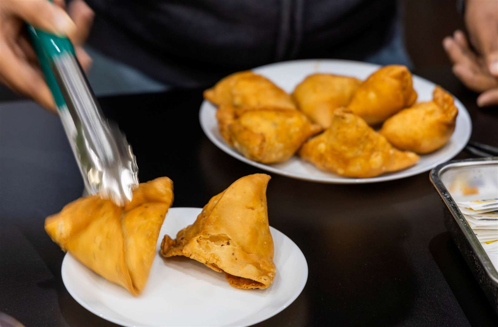 Different Indian snacks and delicacies, including dumplings, are on the menu