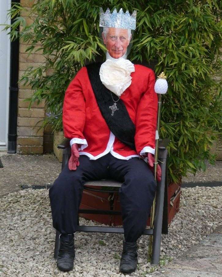 Various handmade royal scarecrows dotted around the village