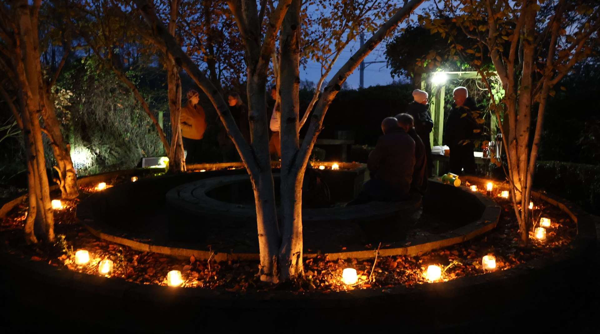 Survivors gathering in the remembrance garden near the site of the crash on Wednesday evening. Credit: Lee Fawkes