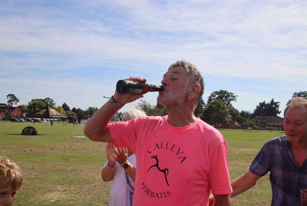 Mr Howells enjoying a well-earned beer after completing his challenge, credit: Pete Hughes