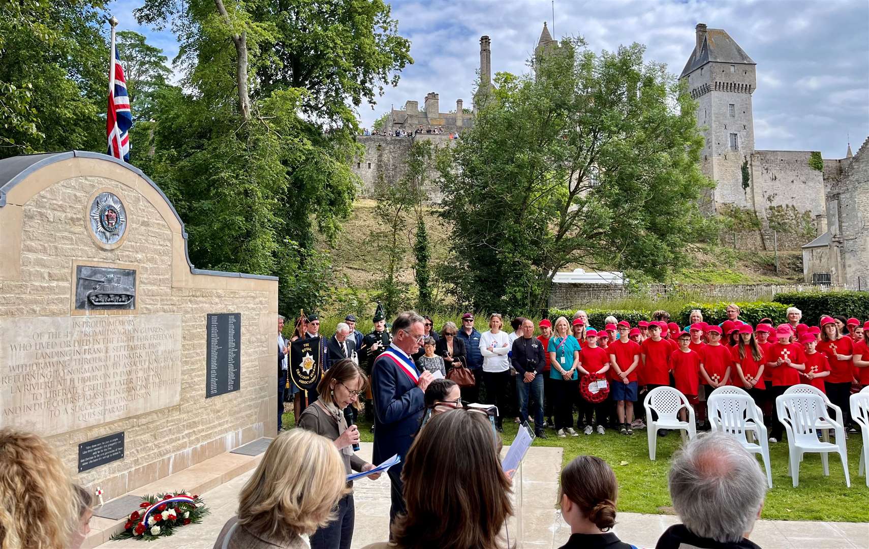 Commemorative service held for Cecil Newton at the 4th/7th Royal Dragoon Guards Memorial at Creully. Visible in the background is the square tower from which the BBC broadcasted about the Normandy campaign to the Home Front and resistance forces. Credit: Mirek Gosney