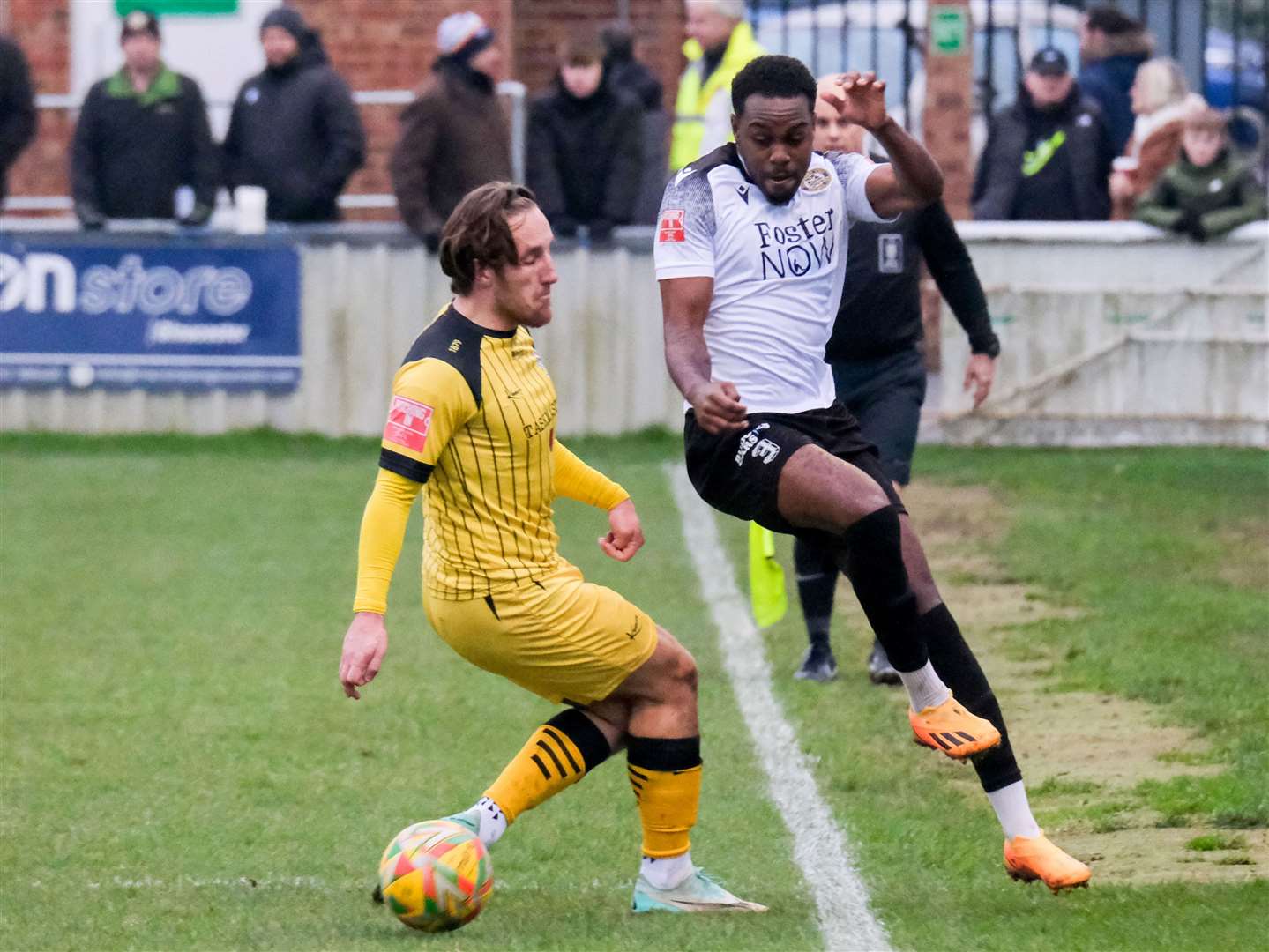 Ramarni Medford-Smith takes on Lewis Rolfe on the touchline