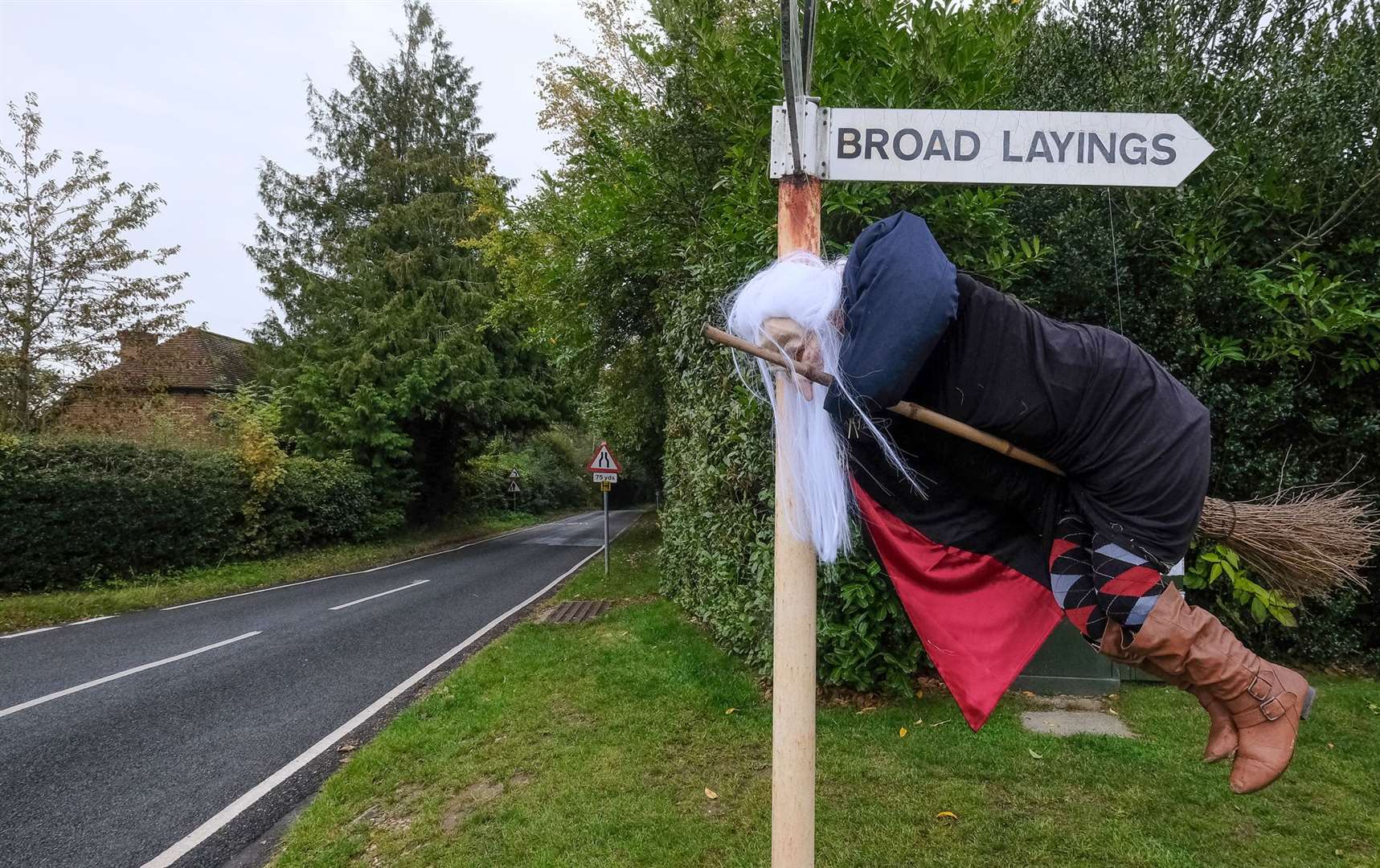 A witch preparing for take-off in the village centre.