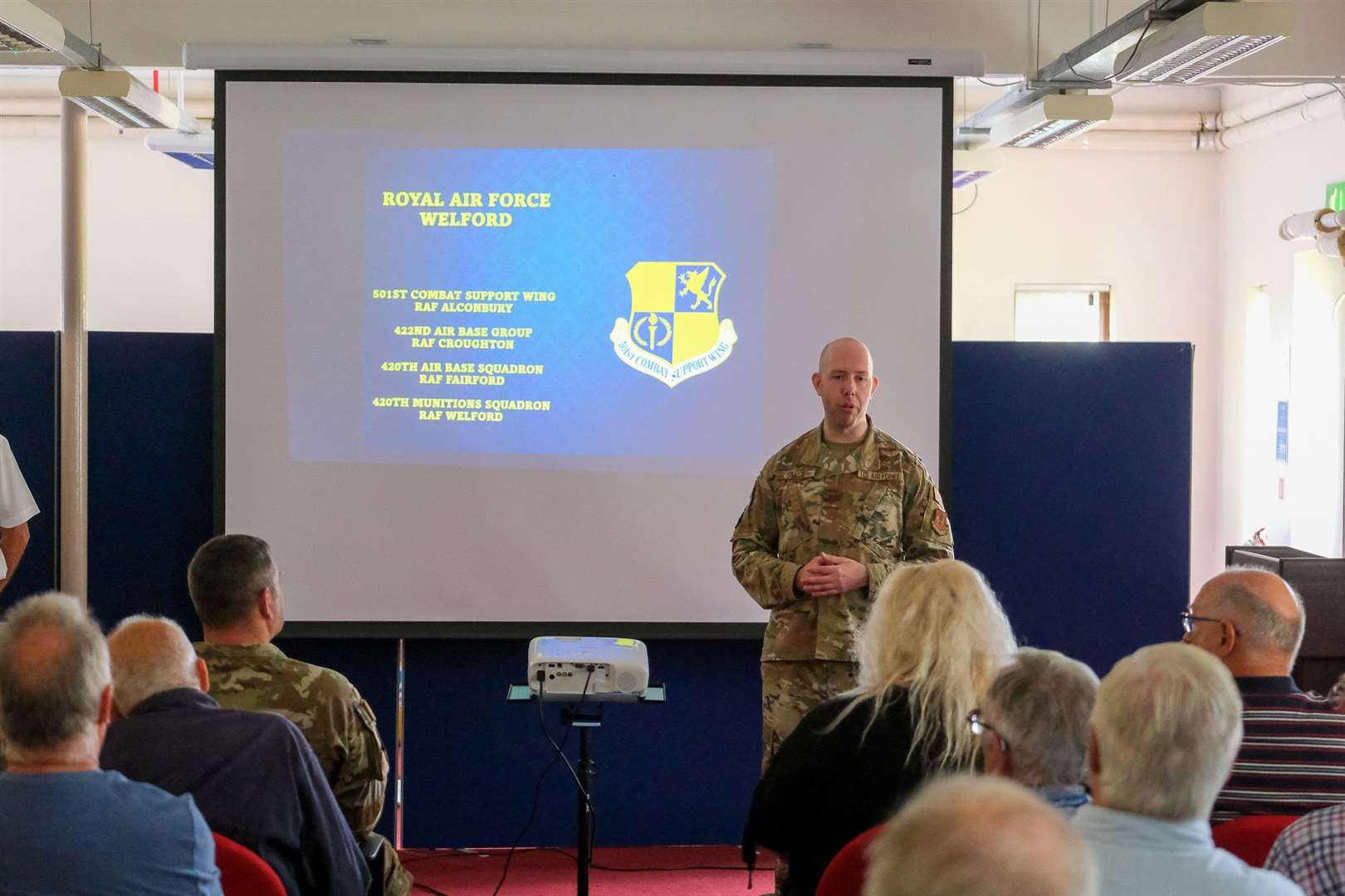 USAF Major Preston Smith addresses the room