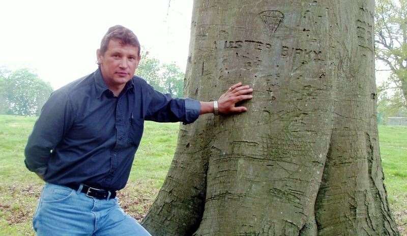 David Birky standing by the tree carving his father made at Hamstead Park. Credit: Michael Dowdeswell