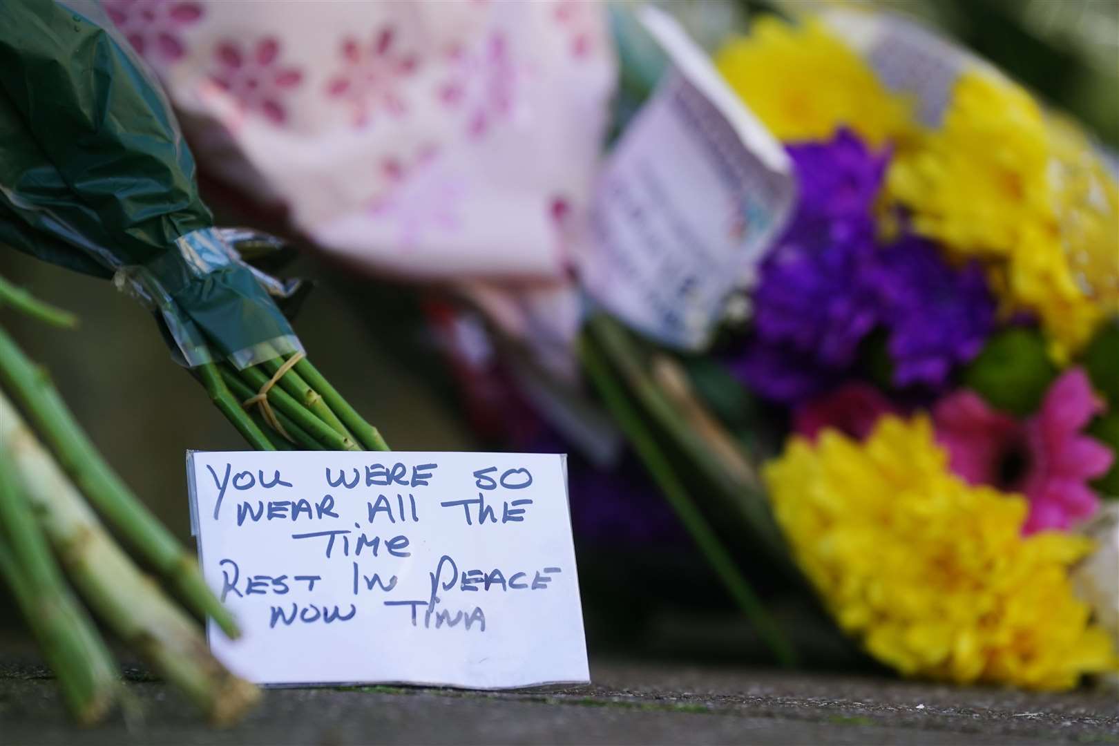 Flowers and messages left near to the scene in Youghal, Co Cork, where Tina Satchwell’s remains were found (Brian Lawless/PA)