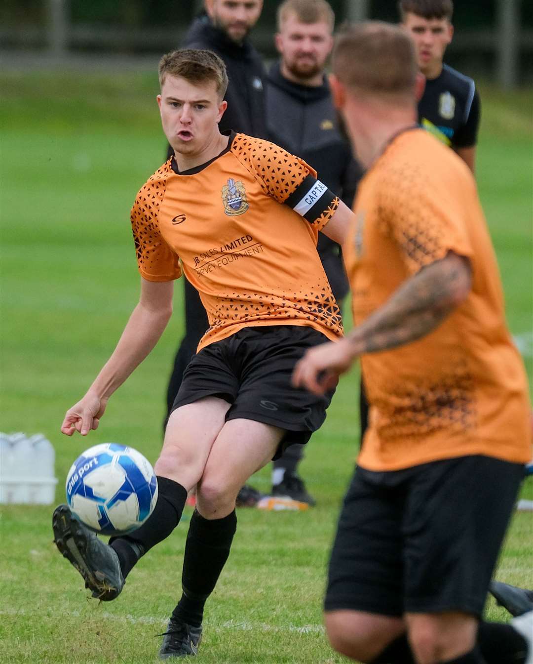 Newbury skipper Luke Polding sends the ball forward