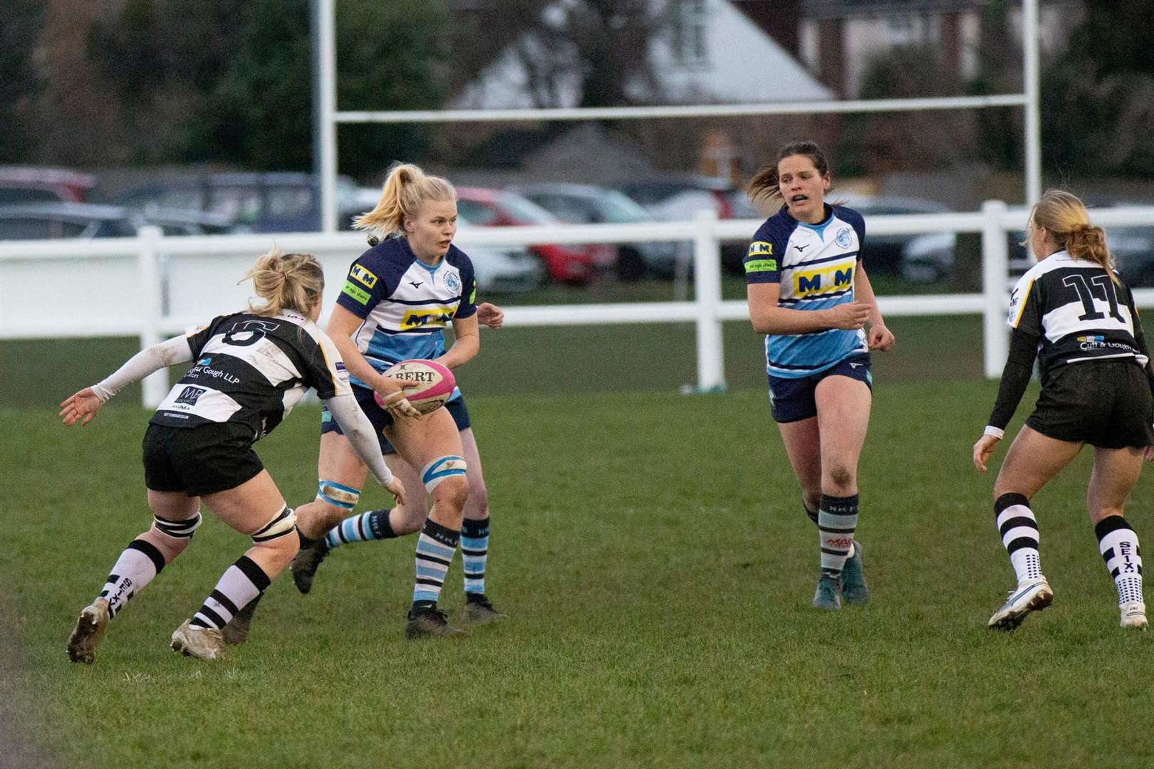 Tilly Burn and Becks Reeves look for gaps in the home side's defence
