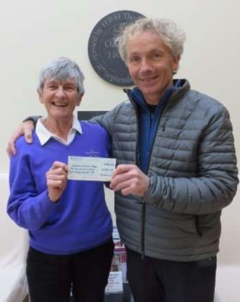 Georgie seaman presents the cheque to John Francome