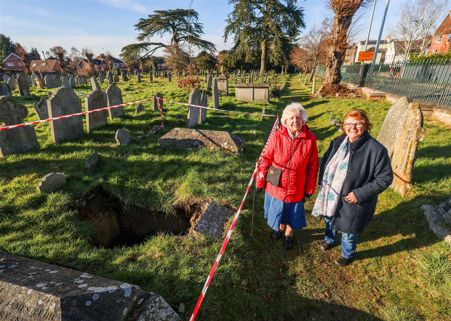 Maureen Hudd and Ros Clow next to the collapsed grave in Newtown Road Cemetery
