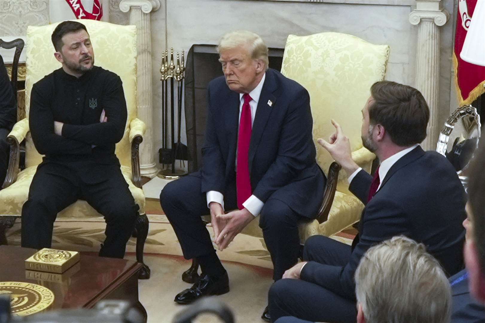 US vice president JD Vance, right, speaks with Ukrainian President Volodymyr Zelenskyy, left, as President Donald Trump listens in the Oval Office at the White House in Washington (Mystyslav Chernov/AP)
