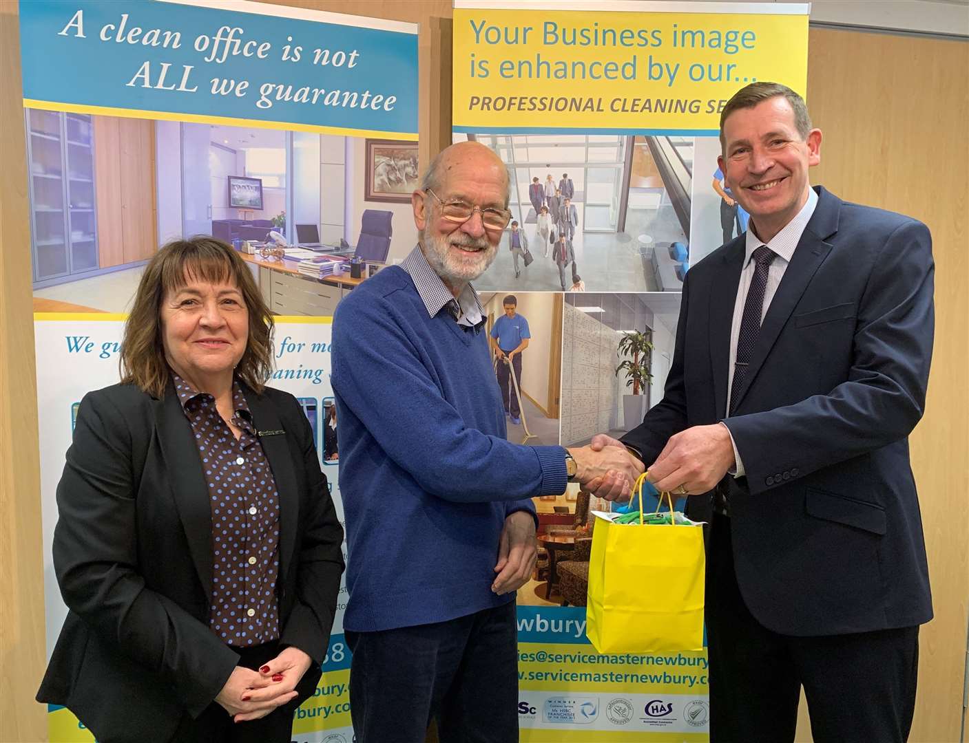 Managing Director Andre Gottemaker and Business Services Director Jane Paisley presenting Peter with the USB sticks. Image supplied by Alexei Jackson