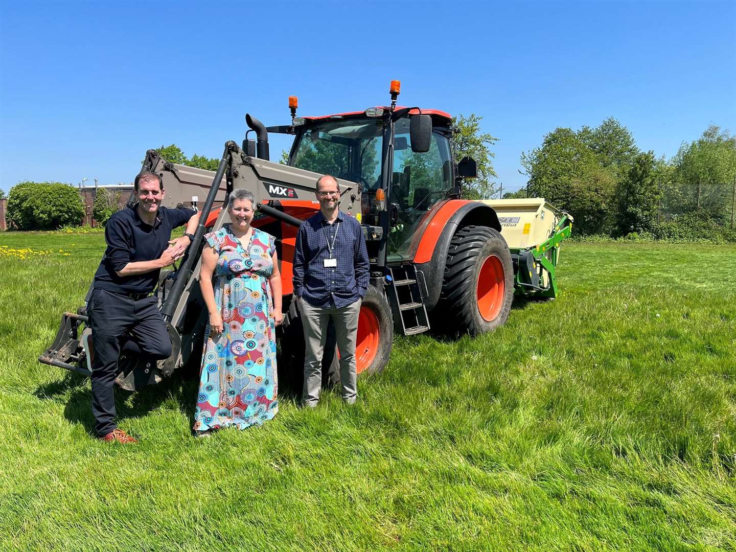 Councillors Lee Dillon, Janine Lewis and Martin Colston by the tractor and mowing trailor