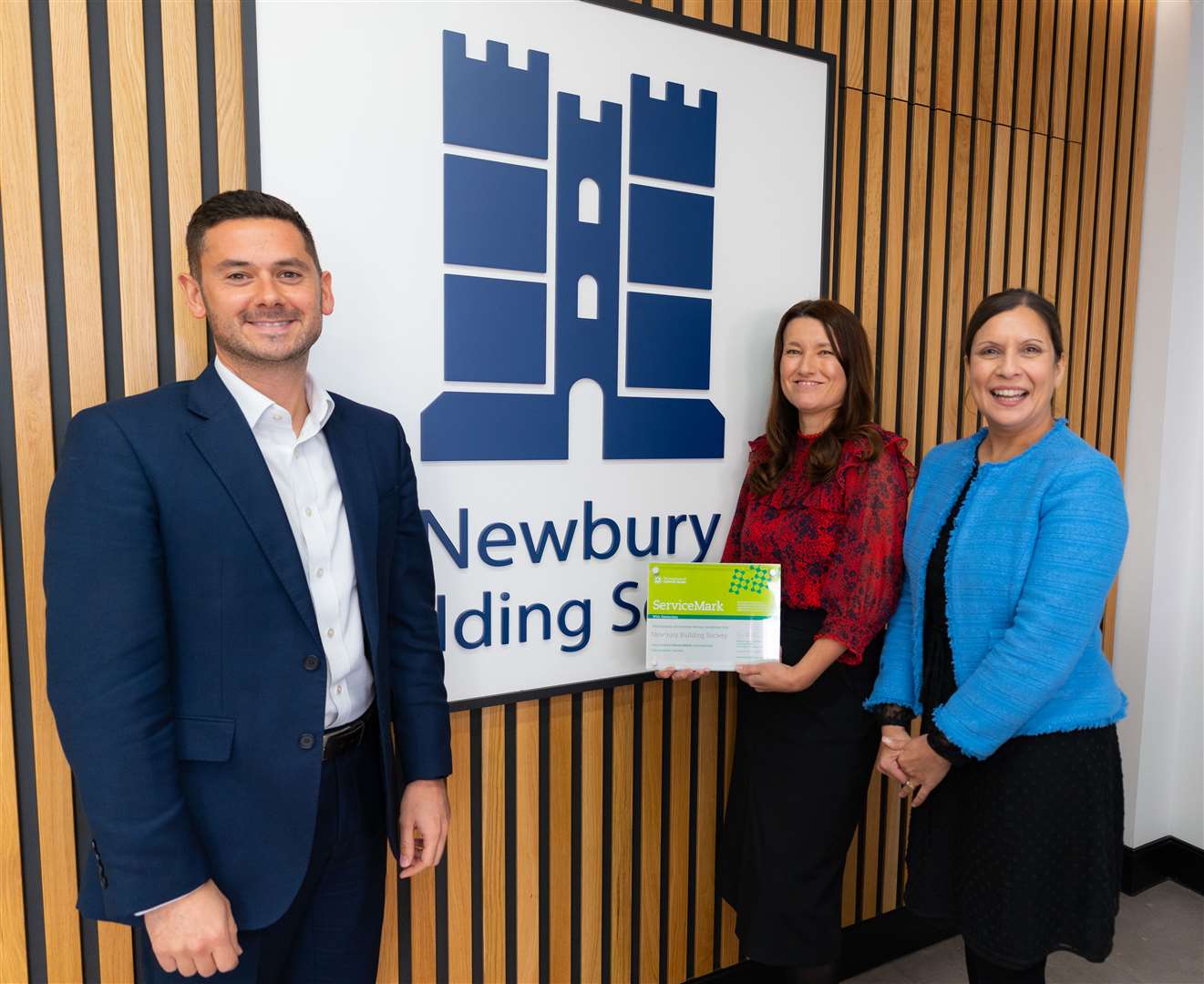 Head of sales and marketing Dean Scott, head of customer service Melanie Mildenhall, and Chief Executive Phillippa Cardno with the ServiceMark plaque at the Society’s Head Office in Newbury, credit: @Michael Harden Photography